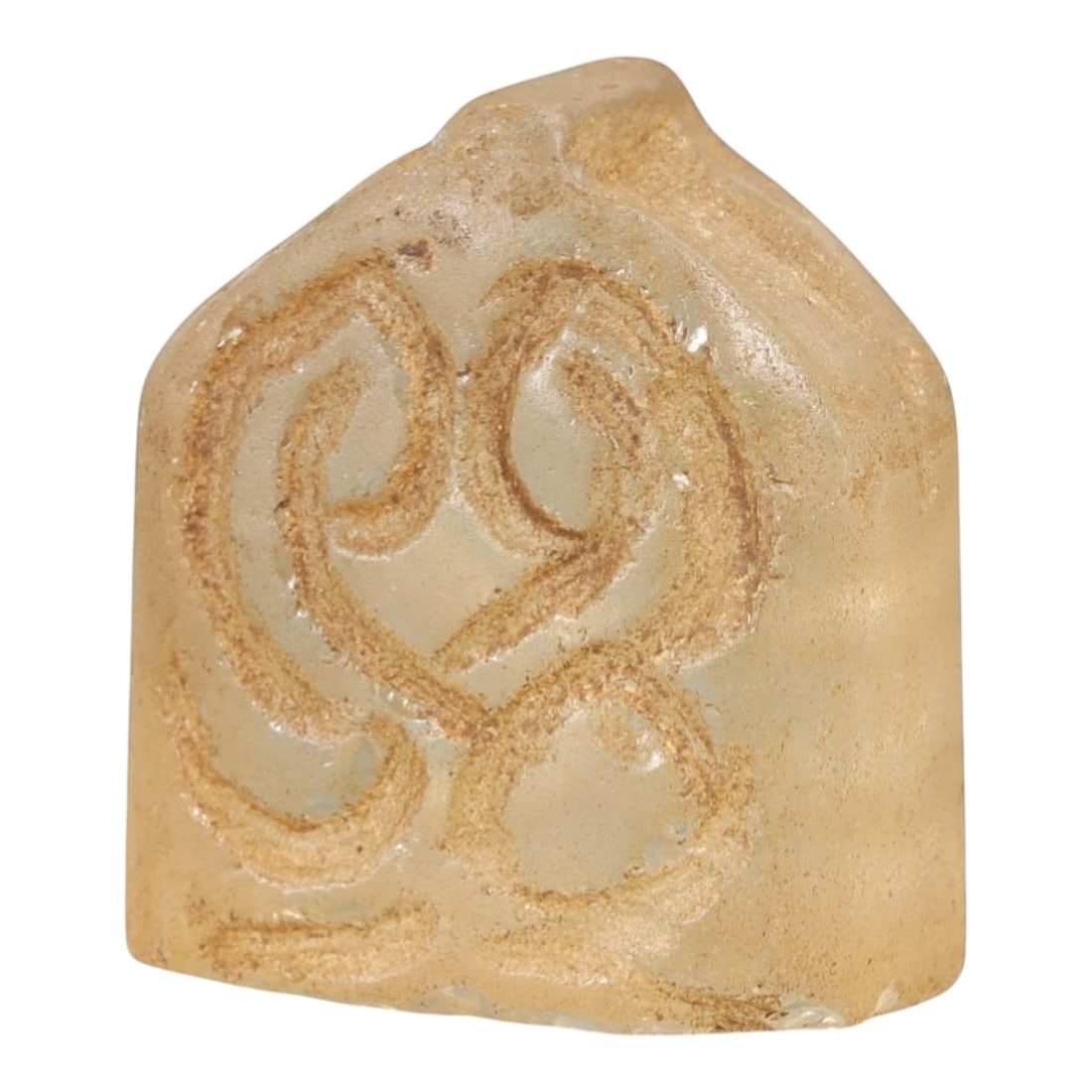Ancient Rock Crystal Relic - Near Eastern Carving, 66AL: This artifact is carved from translucent rock crystal, featuring a compact, block-like form with incised curvilinear decorative motifs across its primary face. The carving exhibits simple, flowing lin