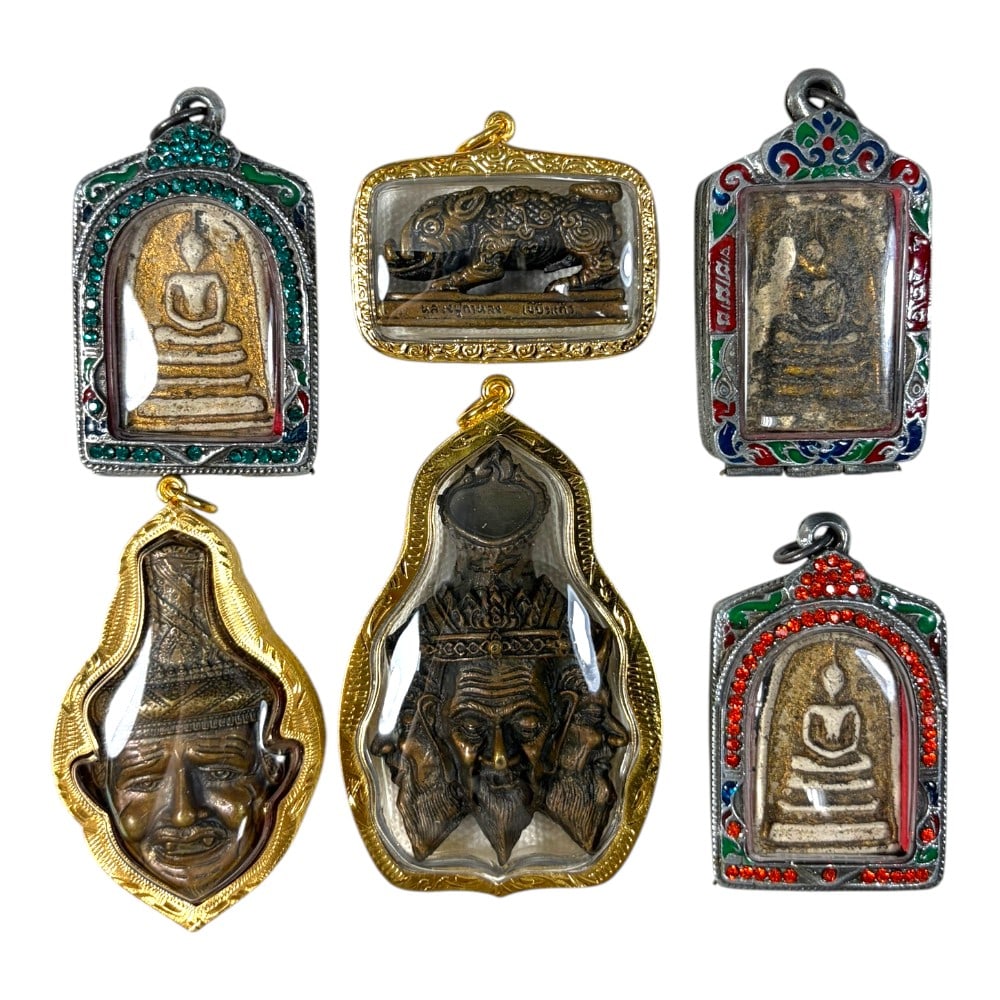A Lot of 6 Vintage Thai Buddhist Amulets with Enamel and Jewel Accents, 40AA: Comprising six pendants ranging from 4 to 8 cm in height. The collection features a diverse range of sacred imagery, including seated Buddha figures, mythical creatures, and revered hermit (ruesi) bus