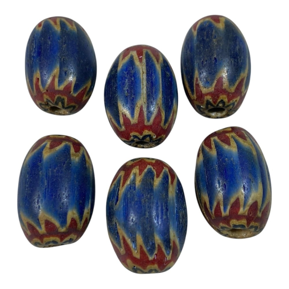 A Lot of 6 Antique Chevron Glass Trade Beads, 92AA: This collection features 6 classic antique chevron glass beads, likely of Venetian or Islamic origin. The beads are barrel-shaped, crafted using the traditional multi-layered "cane" glass technique, w