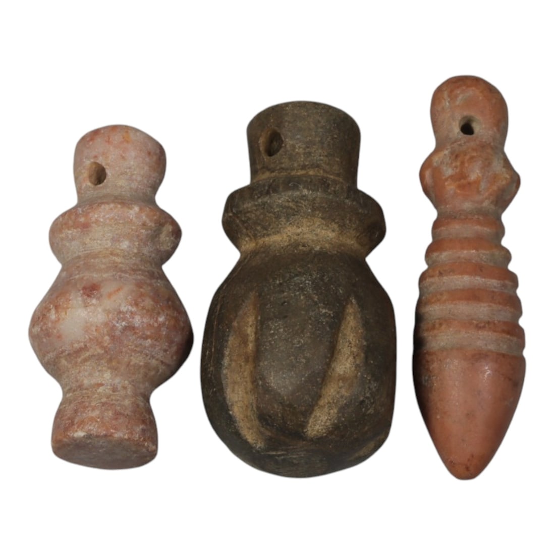 Lot of 3 Ancient Coptic Egyptian Stone Amulets, Circa Roman to Coptic Era, 45WL: Carved from varied red, dark grey, and pinkish stone, this set of three amulets features stylized bulbous and ribbed forms, each with a drilled suspension hole confirming their use as wearable protect