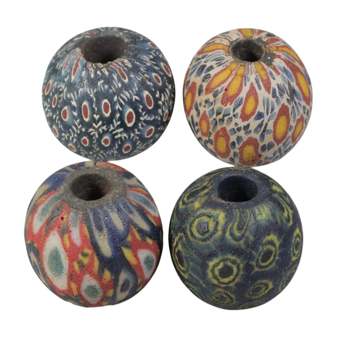 Lot of 4 Ancient to Antique Polychrome Glass Beads, 1st Mil BCE to Islamic Period, 34WM: A group of four spherical polychrome glass beads, each with a central perforation. The beads feature intricate mosaic and millefiori-style decoration, including eye motifs, feather patterns, and compo