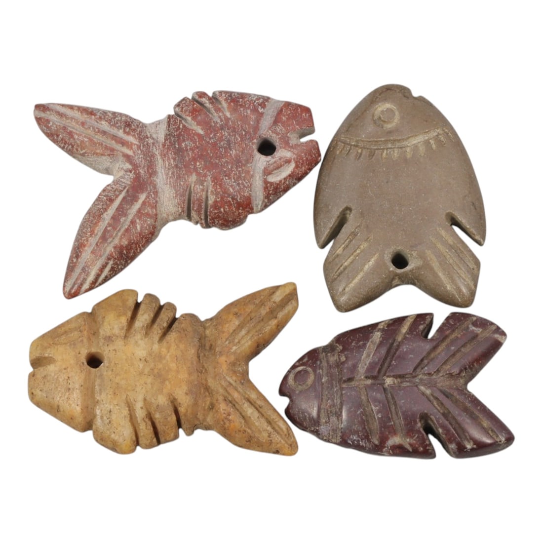 Lot of 4 Ancient Coptic Egyptian Stone Fish Amulets, Circa Roman to Coptic Era, 80WL: A group of four stylized fish amulets carved from stone, characteristic of protective symbolism in Roman to Coptic period Egypt. Each amulet features a suspension hole for wear as a pendant. The examp