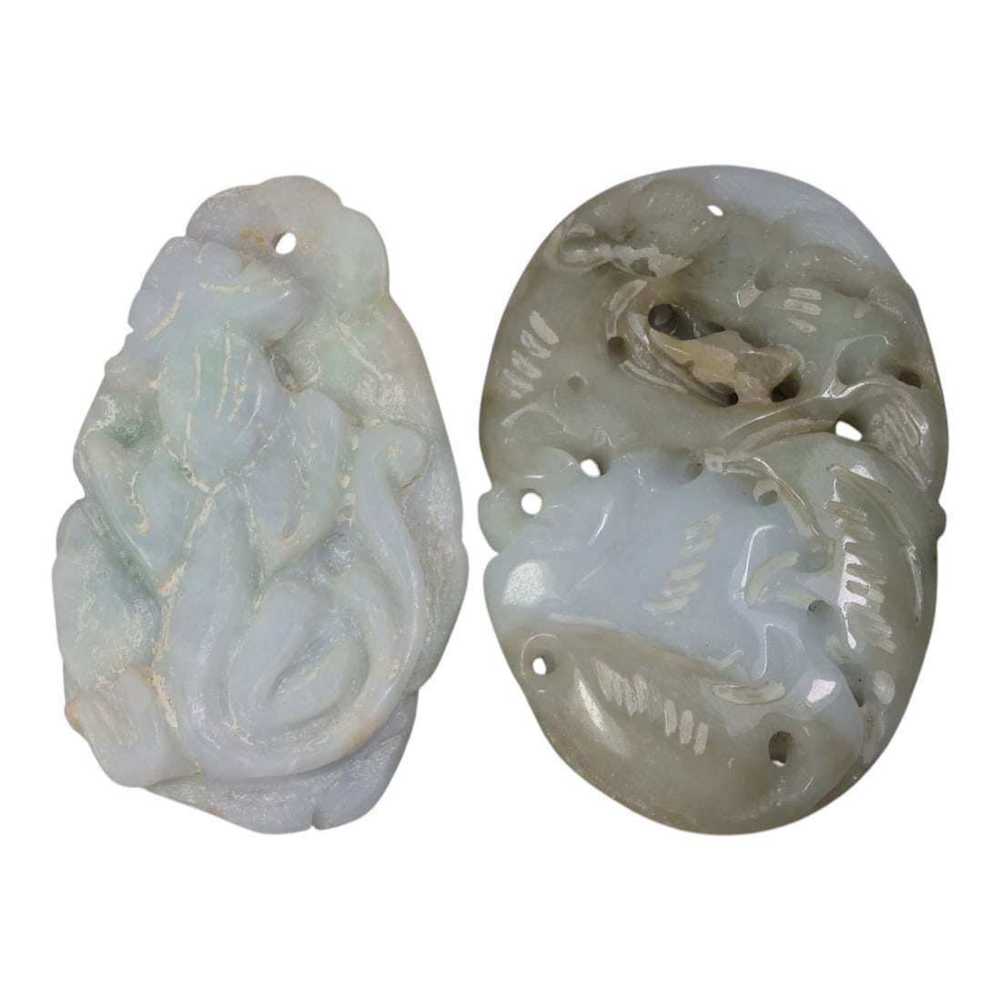 Lot of 2 Antique Oriental Chinese Jadeite Jade Carved Pendants, 42AG: The lot comprises two free-form jadeite pendants. The left pendant is carved from pale lavender-green jadeite with faint mottling, depicting a stylized mythical beast in relief, with simplified incise