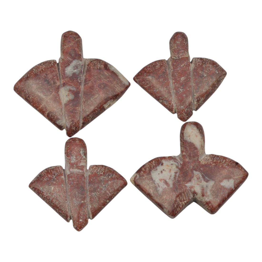 Lot of 5 Ancient Coptic Egyptian Red Stone Amulets, Circa Roman to Coptic Era, 8WL: Carved from rich red stone with natural white inclusions and contrasting incised detailing, this matched set of five stylized leaf or bird-form amulets each feature a drilled suspension hole confirmin