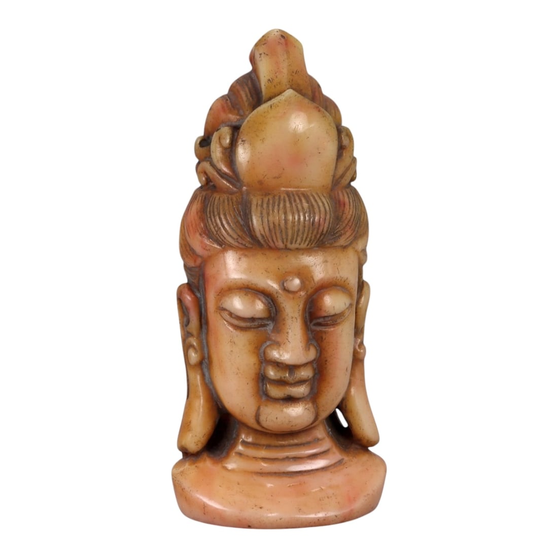 A Chinese Carved Stone Head of a Bodhisattva, 20th Century, 31YB: Carved from a warm-toned stone or hard composite material with mottled beige and light brown coloration, the sculpture represents a bodhisattva head mounted on an integral plinth base. The face is ren