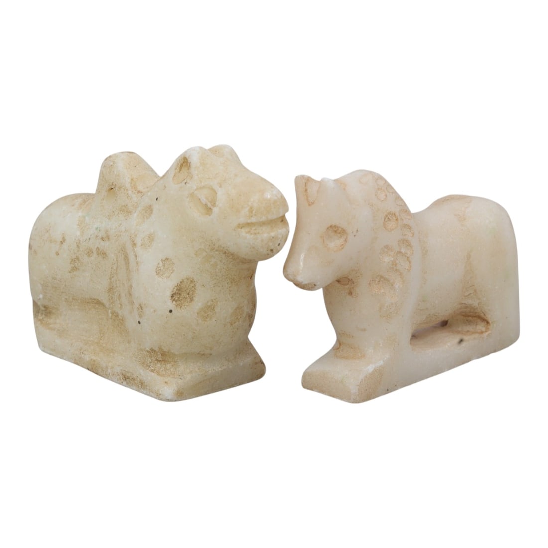Lot of 2 Ancient Near Eastern Marble Zoomorphic Amulets, c. Iron Age to Sasanian Period, 4WL: A pair of finely carved marble zoomorphic amulets from the Ancient Near East, depicting recumbent quadruped forms, likely representing camels and horses, with simplified anatomical detailing and suspe