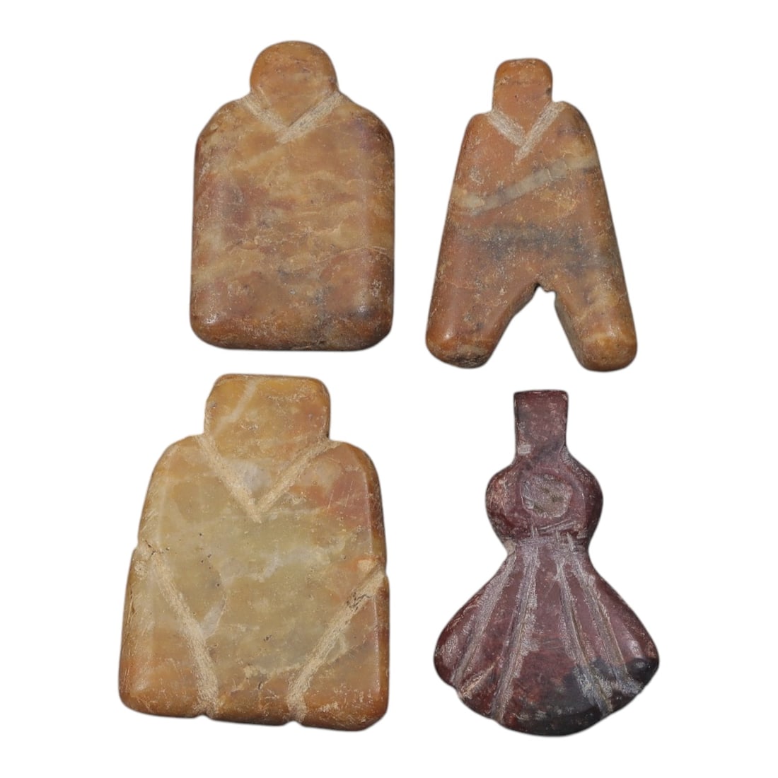 Lot of 4 Ancient Coptic Egyptian Stone Amulets, Circa Roman to Coptic Era, 18AE: The group comprises four carved stone amulets of stylized forms, including anthropomorphic and geometric types. Three examples are worked in light brown to yellowish stone, while one is carved in redd