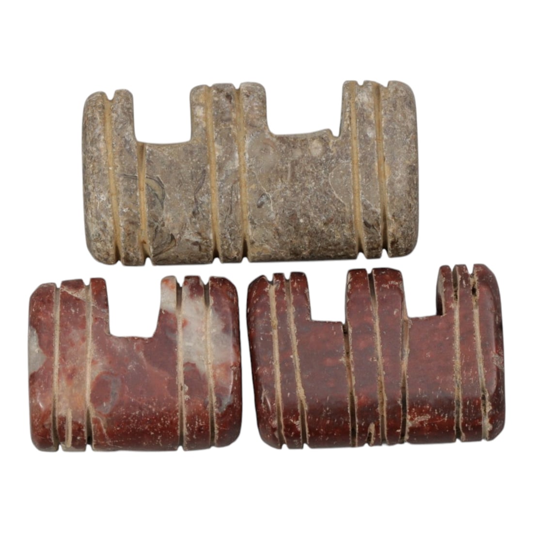Lot of 3 Islamic Period Stone Amulets, Circa Medieval Period, 62WL: A group of three hand-carved amulets attributed to the Islamic medieval period, crafted from natural stone in two distinct tones: light greyish-brown and deep red with subtle veining, all exhibiting s