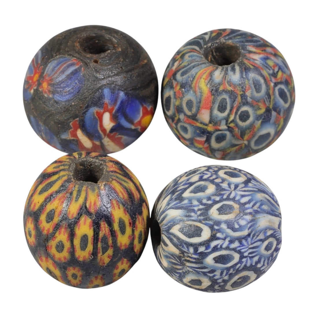 Lot of 4 Ancient to Antique Polychrome Glass Beads, 1st Mil BCE to Islamic Period, 36WM: A group of four spherical polychrome glass beads, each with a central perforation. The beads feature intricate mosaic and millefiori-style decoration, including eye motifs, floral patterns, and compos