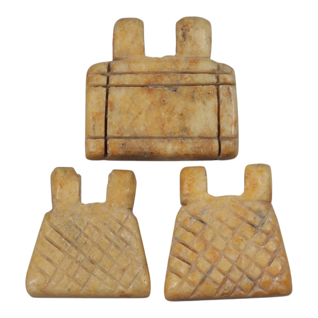 Lot of 3 Achaemenid Steatite Amulets, Circa 5th-4th Century BCE, 70AE: Comprising three flat-backed, trapezoidal steatite amulets with double suspension loops at the top. One example features incised horizontal and vertical lines forming a framed rectangular design on it