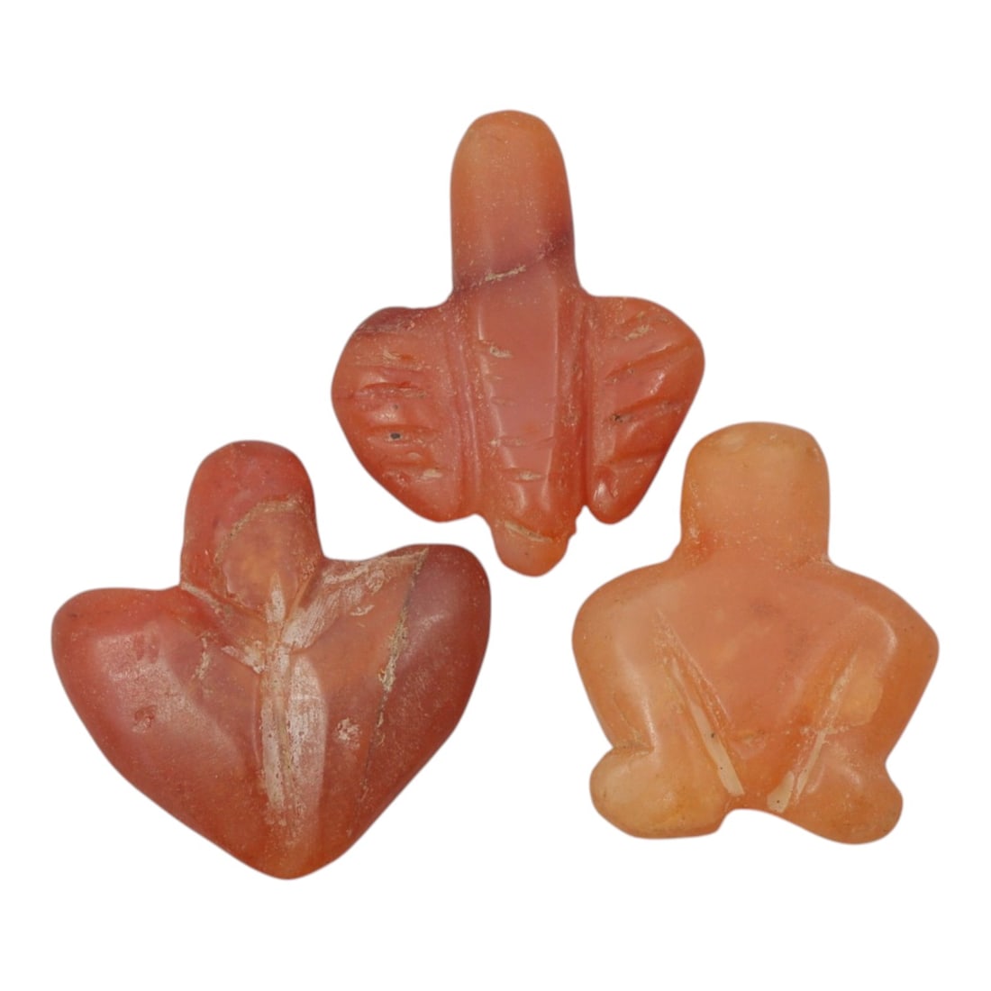 Lot of 3 Ancient Coptic Egyptian Carnelian Zoomorphic Amulets, c. Roman Period to Coptic Era, 29WL: Carved from warm, translucent carnelian with natural orange-red hues and subtle weathering, this set includes three stylized zoomorphic amulets, likely representing avian or abstract forms, each with 