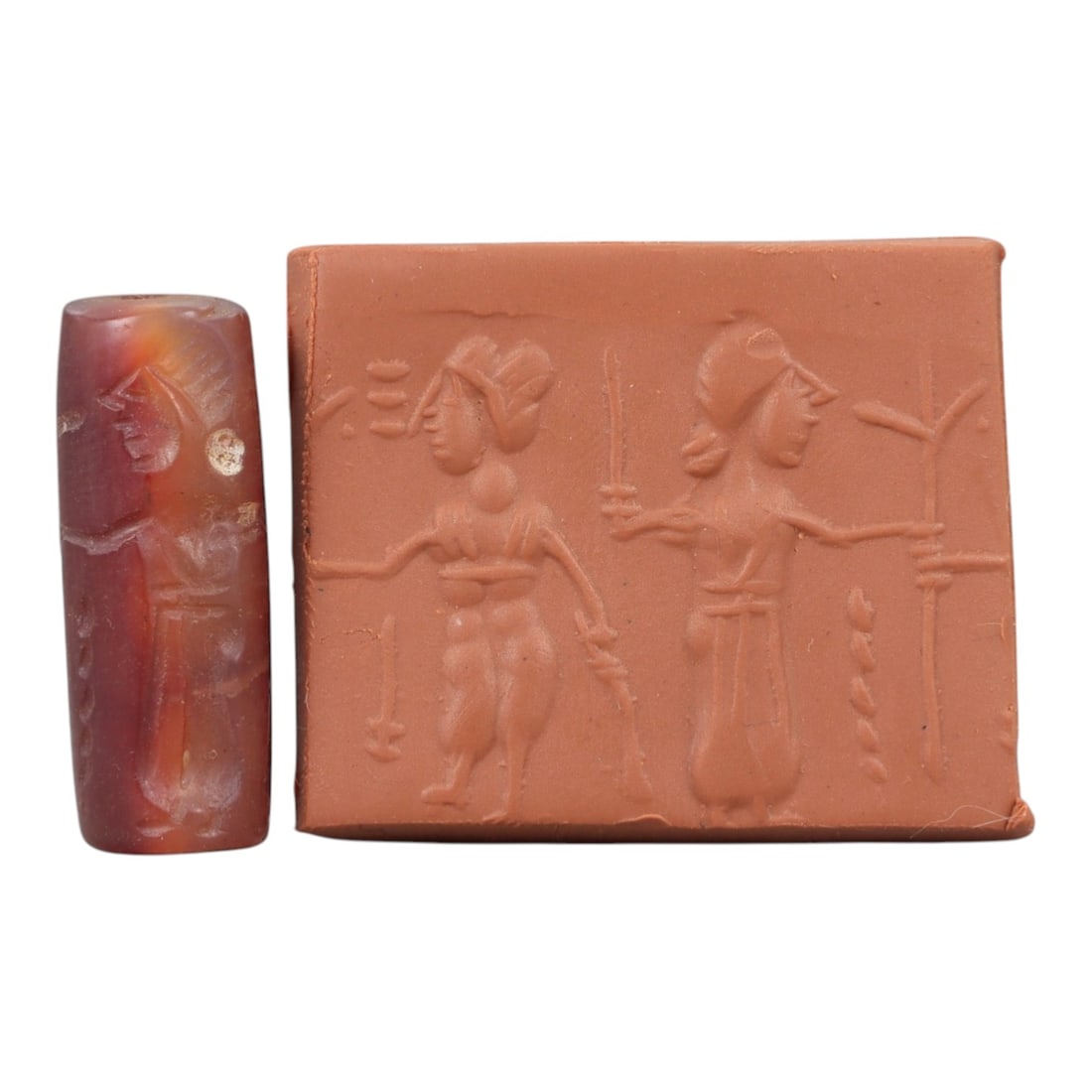 Ancient Carnelian Cylinder Seal - Mesopotamian Figural Procession Scene, 55AN: Carved from richly hued carnelian, this ancient Mesopotamian cylinder seal features a refined linear relief composition of two human figures in procession, one bearing weapons and the other extending 
