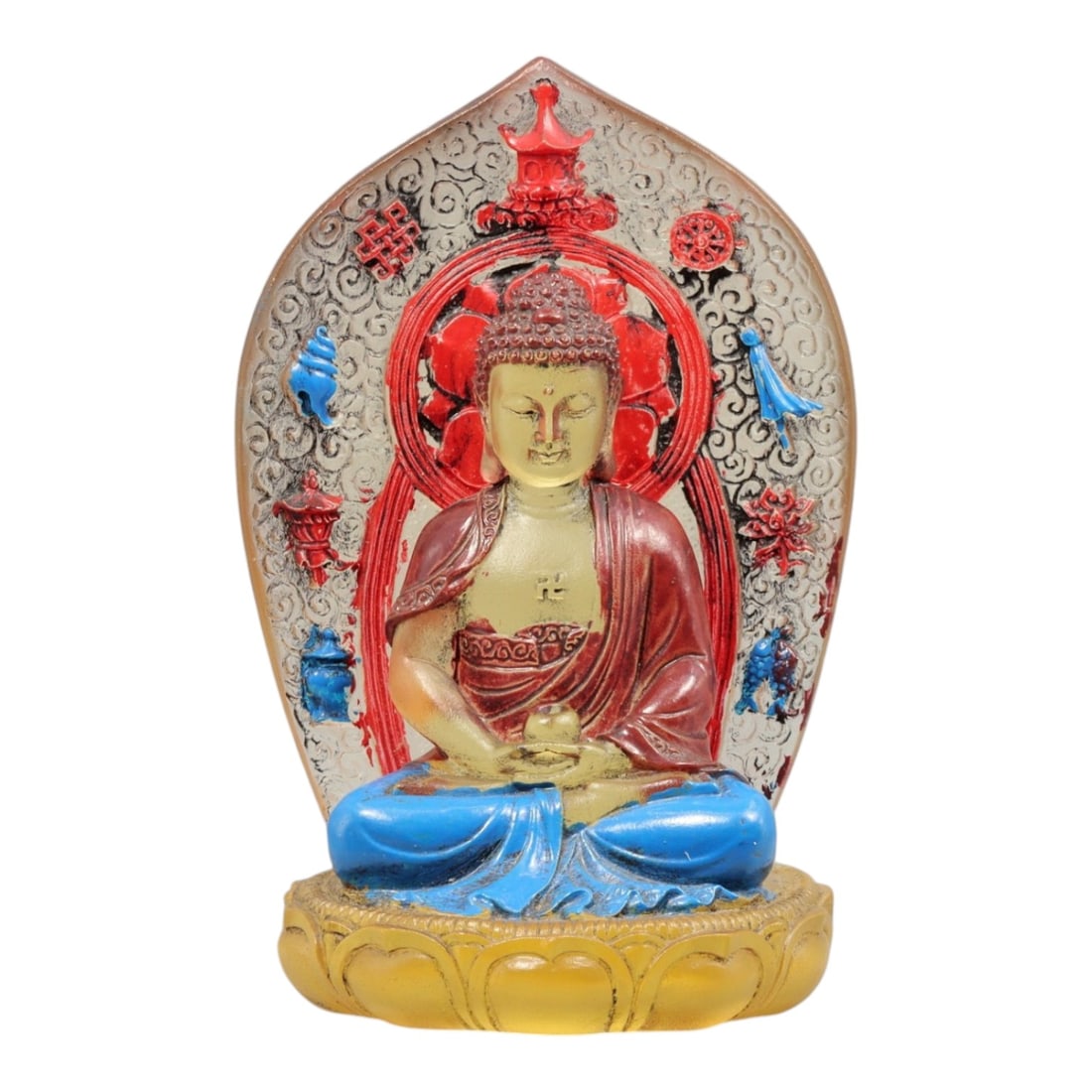A Chinese Glass Seated Buddha Figure, 20th Century, 47YC: The figure is molded from glass and finished with applied polychrome pigments, depicting a seated Buddha shown in meditation posture upon a lotus-form base. The figure is backed by a mandorla decorate