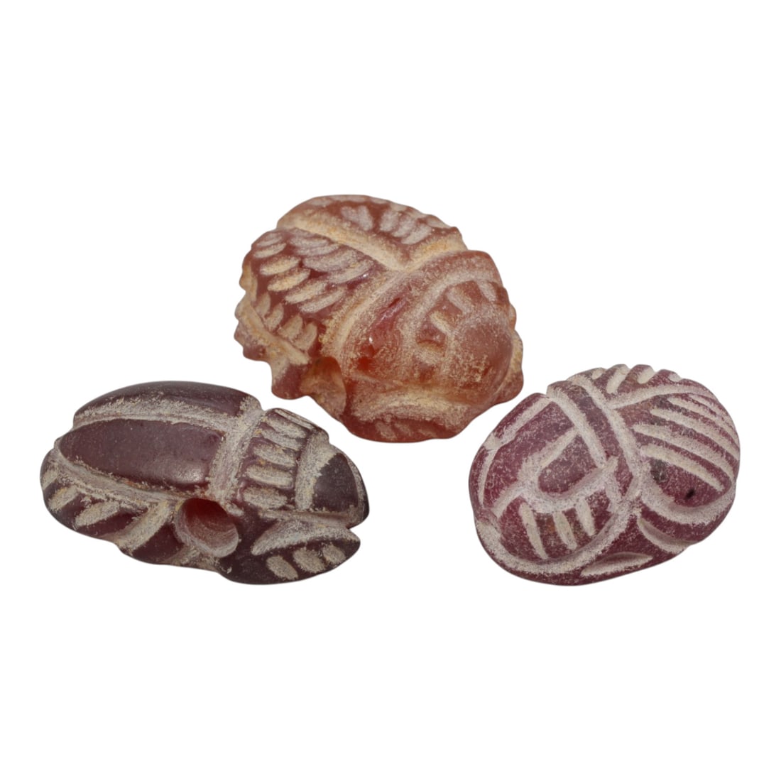 Lot of 3 Ancient Coptic Egyptian Carnelian Scarabs, Circa Roman to Coptic Era, 88WL: Each scarab is carved from carnelian, exhibiting natural reddish-brown to deep crimson hues with surface patination and wear consistent with age. The objects are rendered in the traditional scarab for