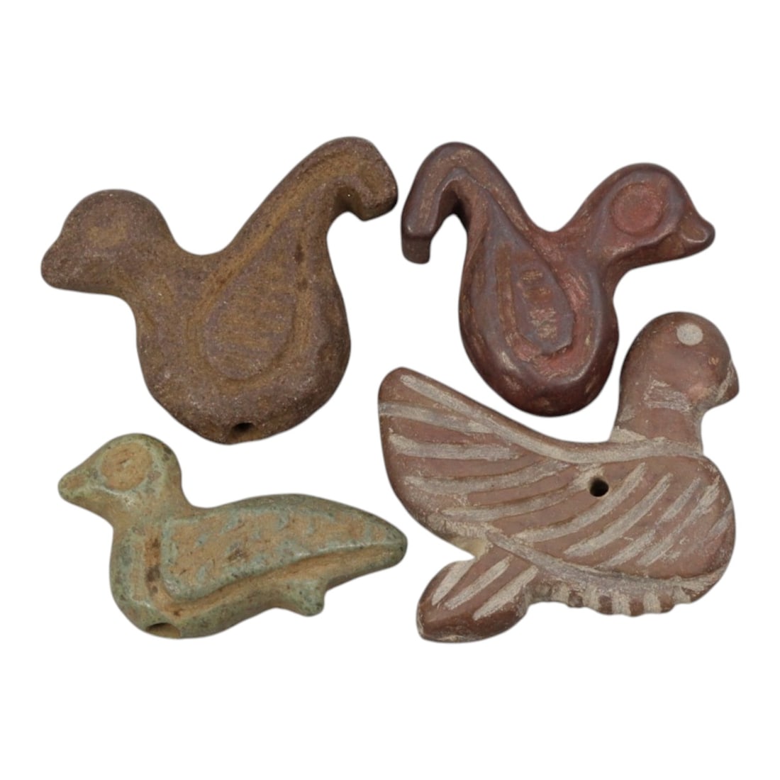 Lot of 4 Ancient Coptic Egyptian Stone Bird Amulets, Circa Roman to Coptic Era, 50WL: A collection of four stylized bird amulets carved from stone, characteristic of Roman to Coptic period Egyptian iconography. Each amulet features a suspension hole for wear as a pendant. The examples 