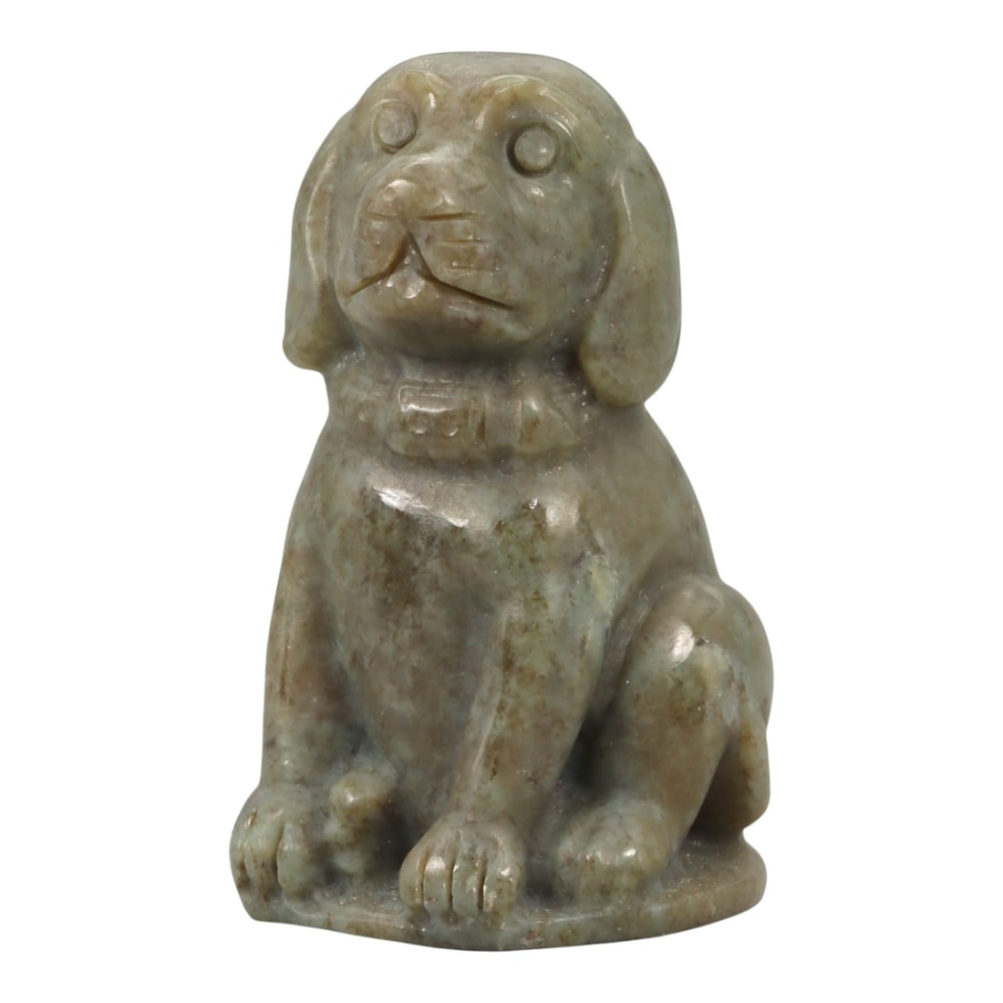 A Chinese Jade Seated Dog Figure, 20th Century, 89YA: Carved from grey-green jade with mottled brown inclusions and areas of soft translucency, the figure is modeled fully in the round as a seated dog shown upright on its haunches. The head is slightly r