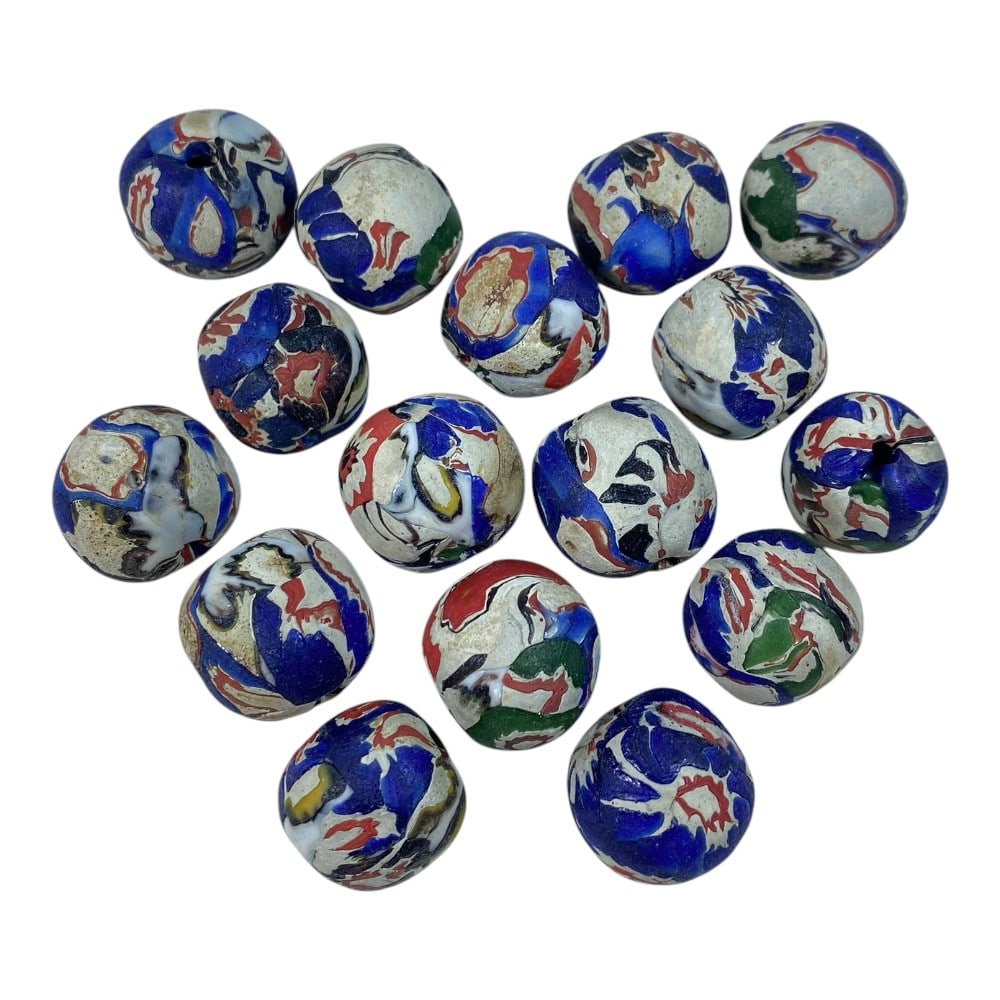 A Lot of 16 Antique Swirled Glass Trade Beads, 80AA: This collection features 16 antique glass beads, characteristic of historical trade bead craftsmanship. Crafted using a swirled and layered glass technique, they showcase a dynamic mix of deep blue, r