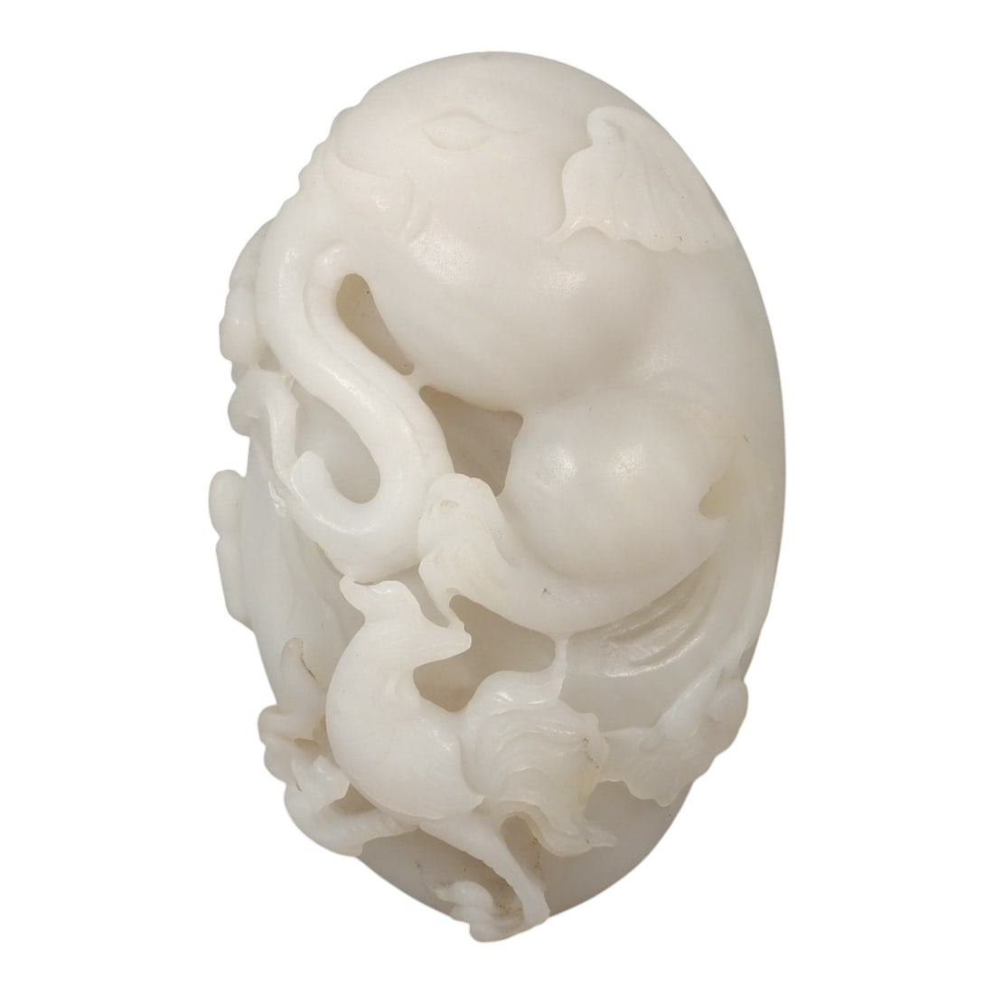 A Chinese Hetian Jade Carving of an Elephant and Phoenix, 20th Century, 9FD: Carved from pale white Hetian jade with a soft, even translucency, the object is worked as an oval-form openwork carving depicting an elephant and a phoenix in an integrated composition. The elephant 