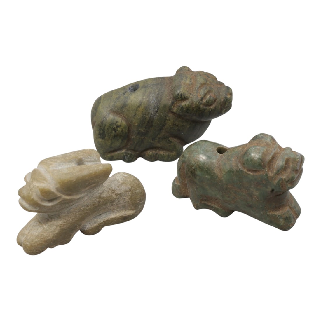Lot of 3 Ancient Bactrian Zoomorphic Amulets, Circa 3rd-1st Millennium BCE, 7WM: A group of three carved stone zoomorphic amulets, each depicting a quadruped animal in a recumbent pose. The amulets are crafted from varied stones including dark green, light green, and pale beige, w