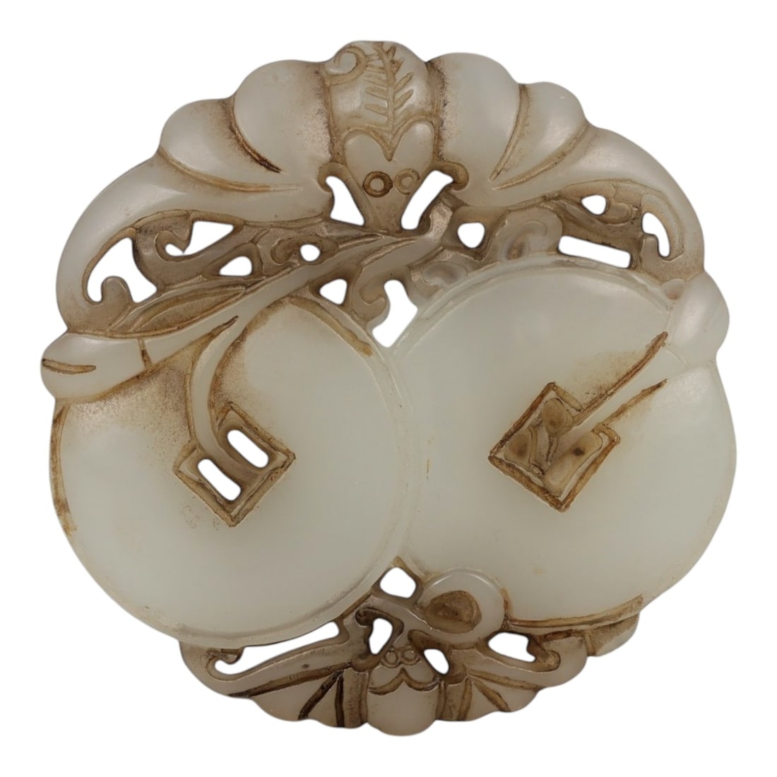A Chinese Hetian Jade Plaque with Bats and Coins, 20th Century, 96FD: Carved from creamy white Hetian jade with light translucency, the plaque is worked in openwork relief and polished overall. The circular form is decorated with stylized bats arranged around paired coi