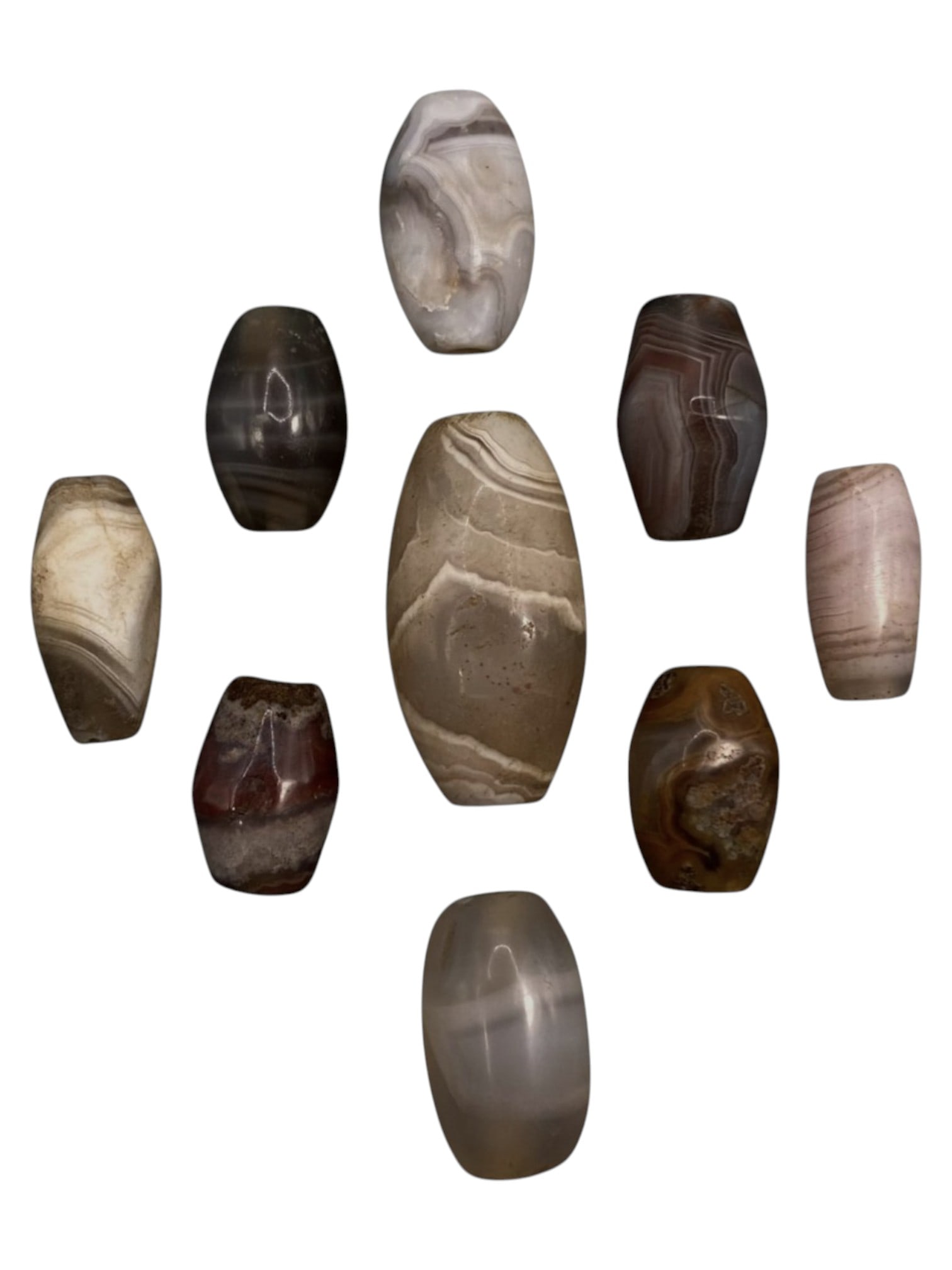 Lot of 9 Himalayan Banded Agate Beads, Ancient to Antique Period, 40WT: A group of nine beads crafted from banded agate, exhibiting a rich palette of natural tones including translucent grey, smoky brown, milky white, reddish-brown, and subtle pinkish hues, with character