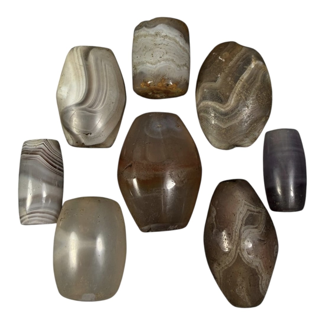 Lot of 8 Himalayan Banded Agate Beads, Ancient to Antique Period, 13AH: A group of eight beads crafted from banded agate with natural color variations, including grey, white, brown, and translucent tones. Each bead exhibits distinct concentric or wavy banding patterns cha