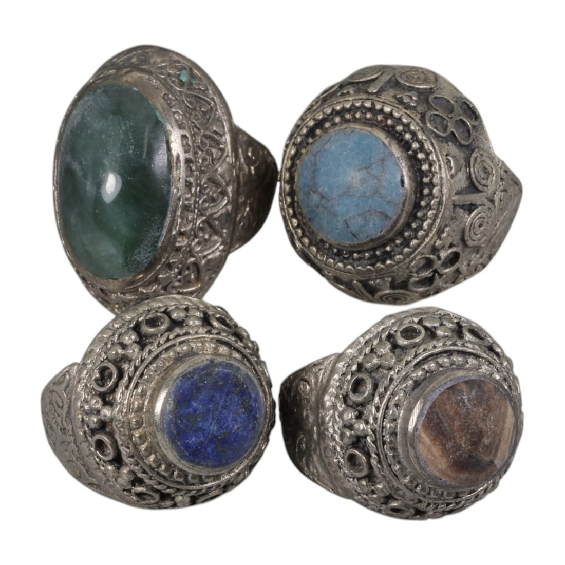 Lot of 4 Vintage Central Asian Tribal Silver-Plated Statement Rings, 66AH: A set of four vintage statement rings, crafted in silver-plated metal with intricate tribal-style ornamentation characteristic of Central Asian or Himalayan jewelry traditions. Each ring features dist