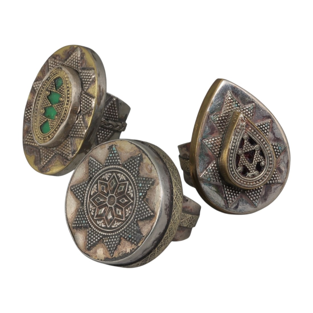 Lot of 3 Vintage North African (Berber / Tuareg) Silver-Plated Gilt Statement Rings, 65AH: A set of three vintage statement rings, crafted in silver-plated metal with gilt accents, featuring traditional North African Berber or Tuareg-inspired designs. The rings display signature motifs of t
