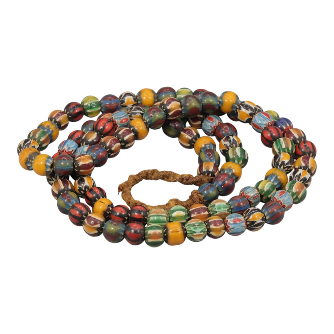 Strand of Antique Chevron Glass Beads, Unstrung, 21AH: A single strand of unstrung antique chevron glass beads, measuring approximately 33 cm in length. The strand features round beads with intricate multicolored chevron patterns, characteristic of tradit