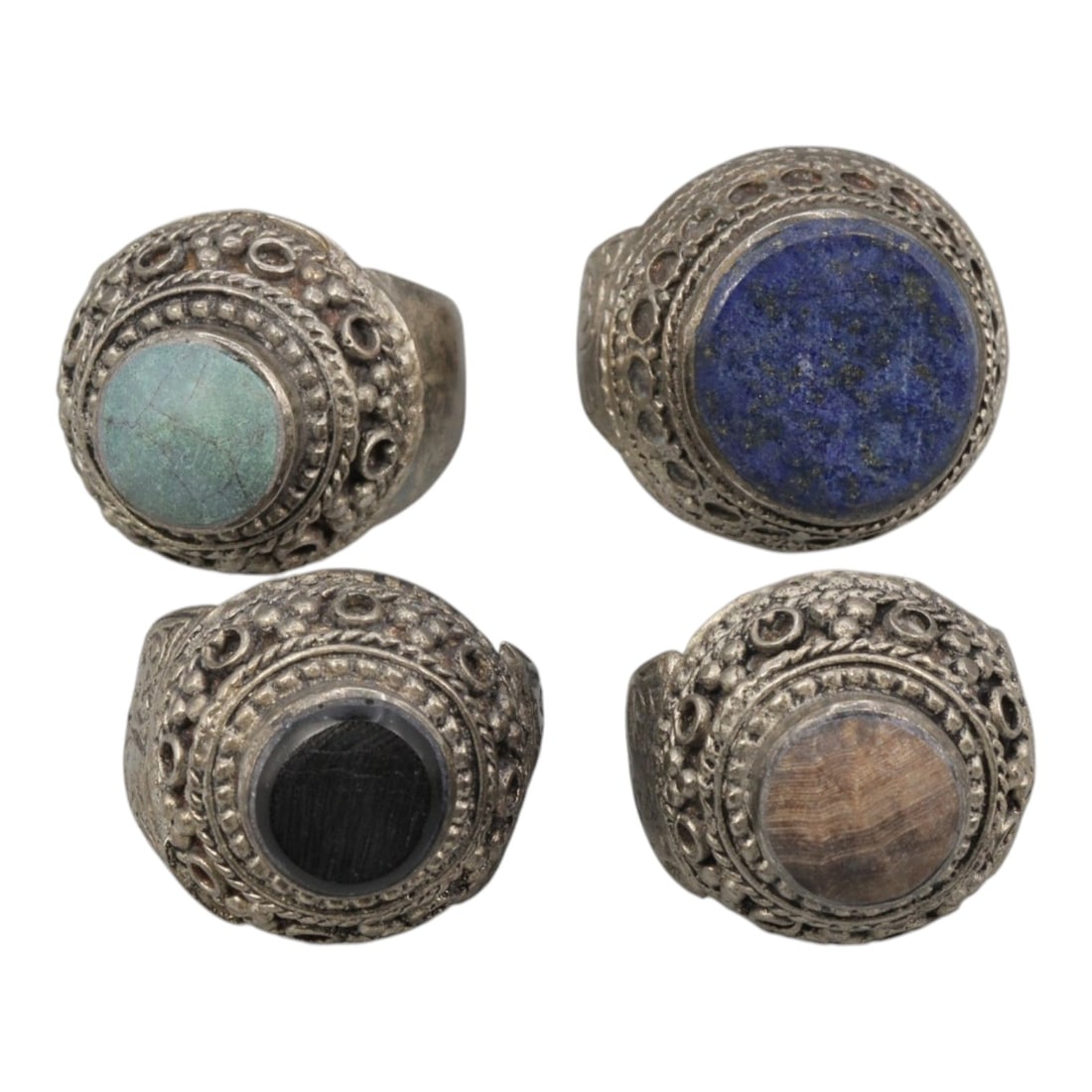 Lot of 4 Vintage Central Asian Tribal Silver-Plated Statement Rings, 74AH: A set of four vintage statement rings, crafted in silver-plated metal with intricate tribal-style ornamentation characteristic of Central Asian or Himalayan jewelry traditions. Each ring features a ci