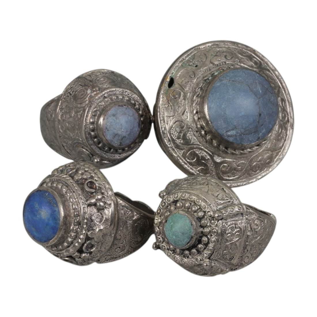 Lot of 4 Vintage Central Asian Tribal Silver-Plated Statement Rings, 45AH: A set of four vintage statement rings, crafted in silver-plated metal with intricate tribal-style ornamentation characteristic of Central Asian or Himalayan jewelry traditions. Each ring features dist