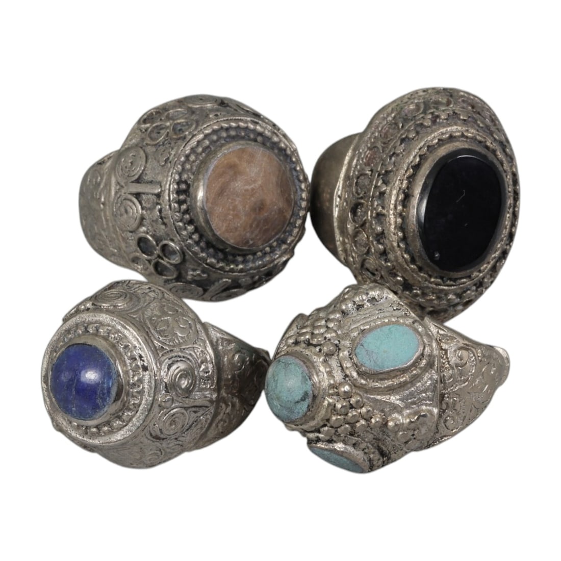 Lot of 4 Vintage Central Asian Tribal Silver-Plated Statement Rings, 51AH: A set of four vintage statement rings, crafted in silver-plated metal with intricate tribal-style ornamentation characteristic of Central Asian or Himalayan jewelry traditions. Each ring features dist