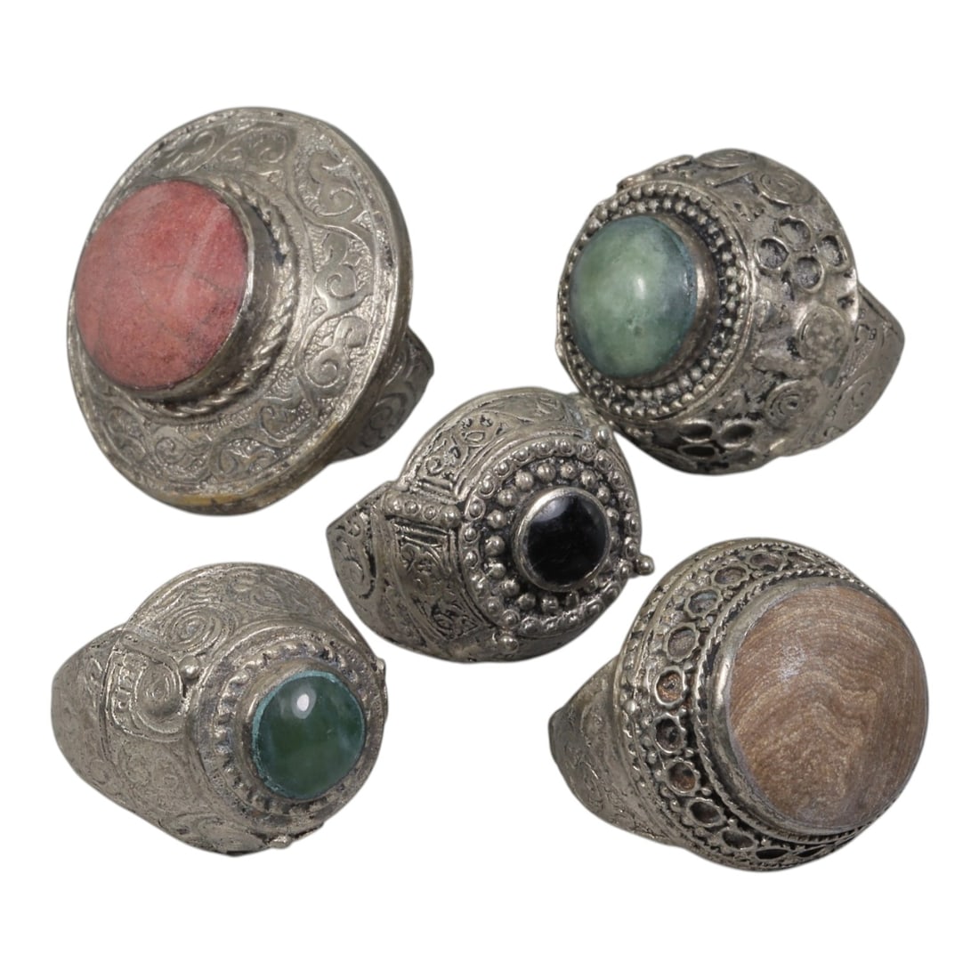 Lot of 5 Vintage Central Asian Tribal Silver-Plated Statement Rings, 10AH: A set of five vintage statement rings, crafted in silver-plated metal with intricate tribal-style ornamentation characteristic of Central Asian or Himalayan jewelry traditions. Each ring features dist