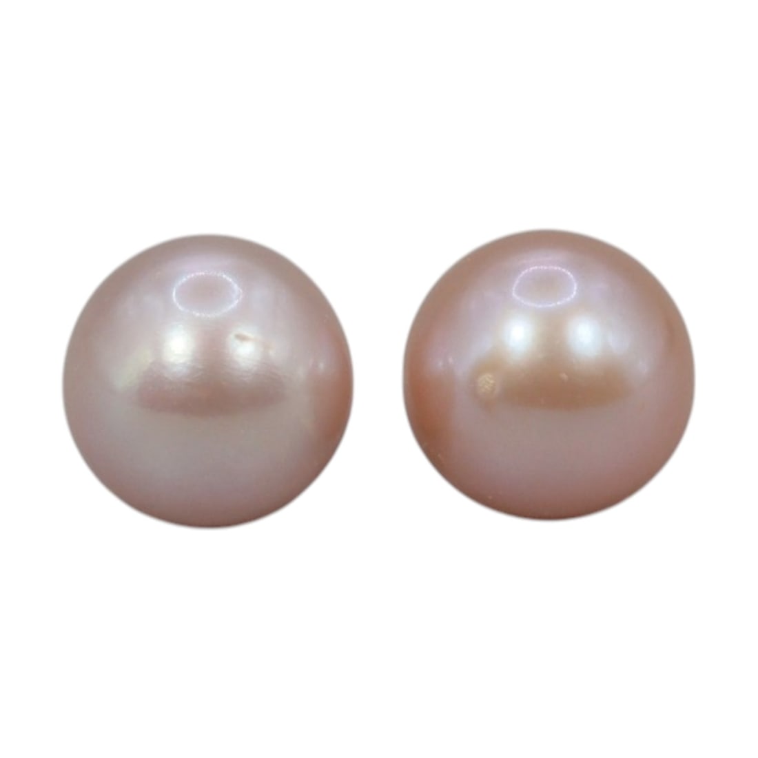 Freshwater Pearl Pair - Natural Pearl Pink Round Gemstones 7mm, 29XA: A matched pair of natural freshwater pearls, exhibiting a soft pinkish-peach hue with bright, even luster and subtle iridescent orient. The pearls are near-spherical, with smooth nacre and minor natur