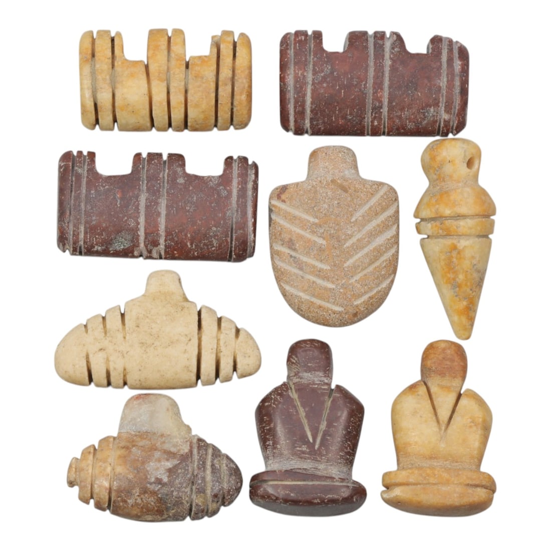 Lot of 9 Ancient Coptic Egyptian Multi-Stone Amulets, Circa Roman to Coptic Era, 98WP: Carved from earth-toned stones including red marble, beige limestone, and yellowish stone, the group consists of nine distinct amulets, each approximately 2.5 cm (0.98 in.) in size. The set features a