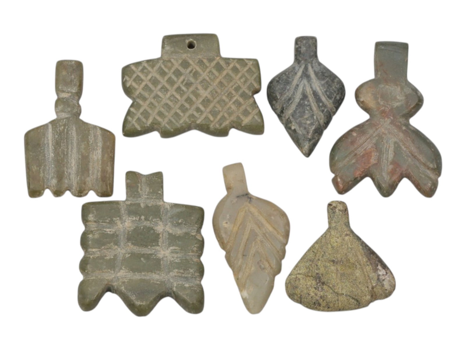 Lot of 7 Ancient Coptic Egyptian Multi-Stone Amulets, Circa Roman to Coptic Era, 85WT: Carved from various greenish and greyish stones, including translucent light stone and speckled varieties, the group consists of seven distinct amulets, ranging in size from 1.5 cm to 2 cm (0.59-0.79 