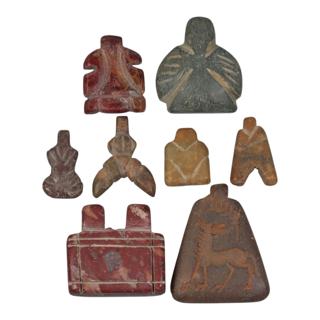 Lot of 8 Ancient Coptic Egyptian Multi-Stone Amulets, Circa Roman to Coptic Era, 88AH: Carved from various earth-toned stones including reddish-brown, dark green serpentine, yellowish marble, and brown varieties, the group consists of eight distinct amulets, ranging in size from 1.5 cm 