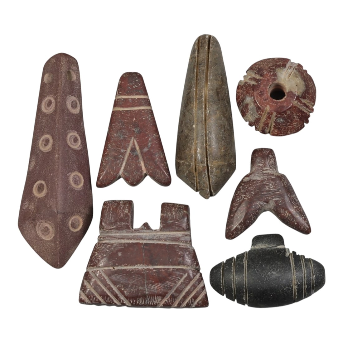 Lot of 7 Ancient Coptic Egyptian Multi-Stone Amulets, Circa Roman to Coptic Era, 95AH: Carved from various earth-toned stones including reddish-brown, dark grey, and speckled varieties, the group consists of seven distinct amulets, ranging in size from 2 cm to 5.5 cm (0.79-2.17 in.). Th