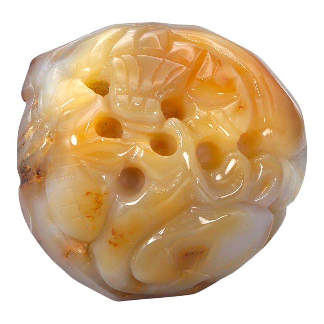A Chinese Chalcedony Pebble Carving, 20th Century, 20YB: Carved from translucent chalcedony displaying natural white and honey-toned banding with areas of iron-oxide staining, the object is worked from a rounded pebble form retaining its organic outline. Th
