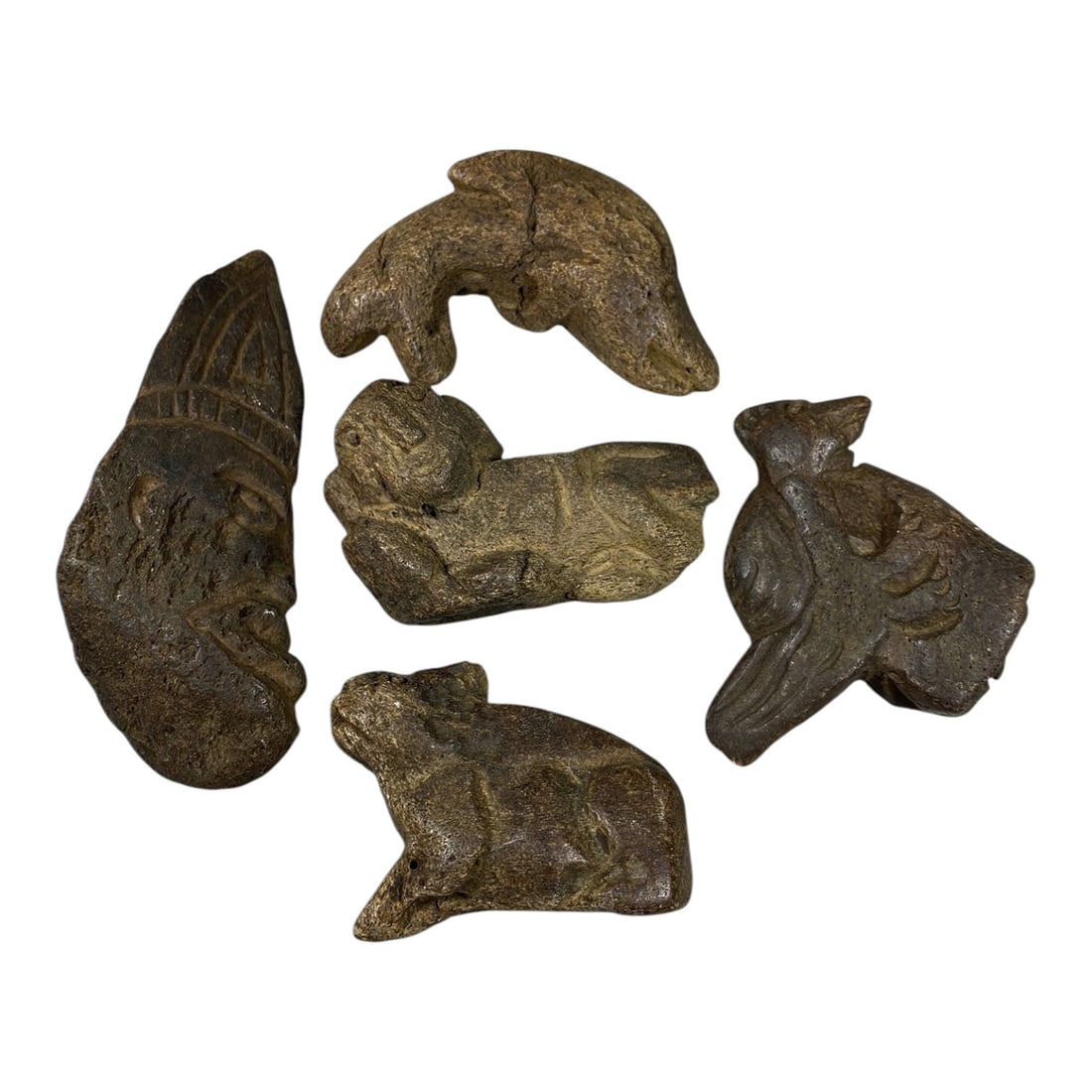 Lot of 5 Medieval Tribal Stone Carvings, Mediterranean Region, 79AG: A collection of five hand-carved stone figurines attributed to medieval tribal cultures of the Mediterranean region. Crafted from dark, weathered stone with a rich earthy patina, the carvings show cle