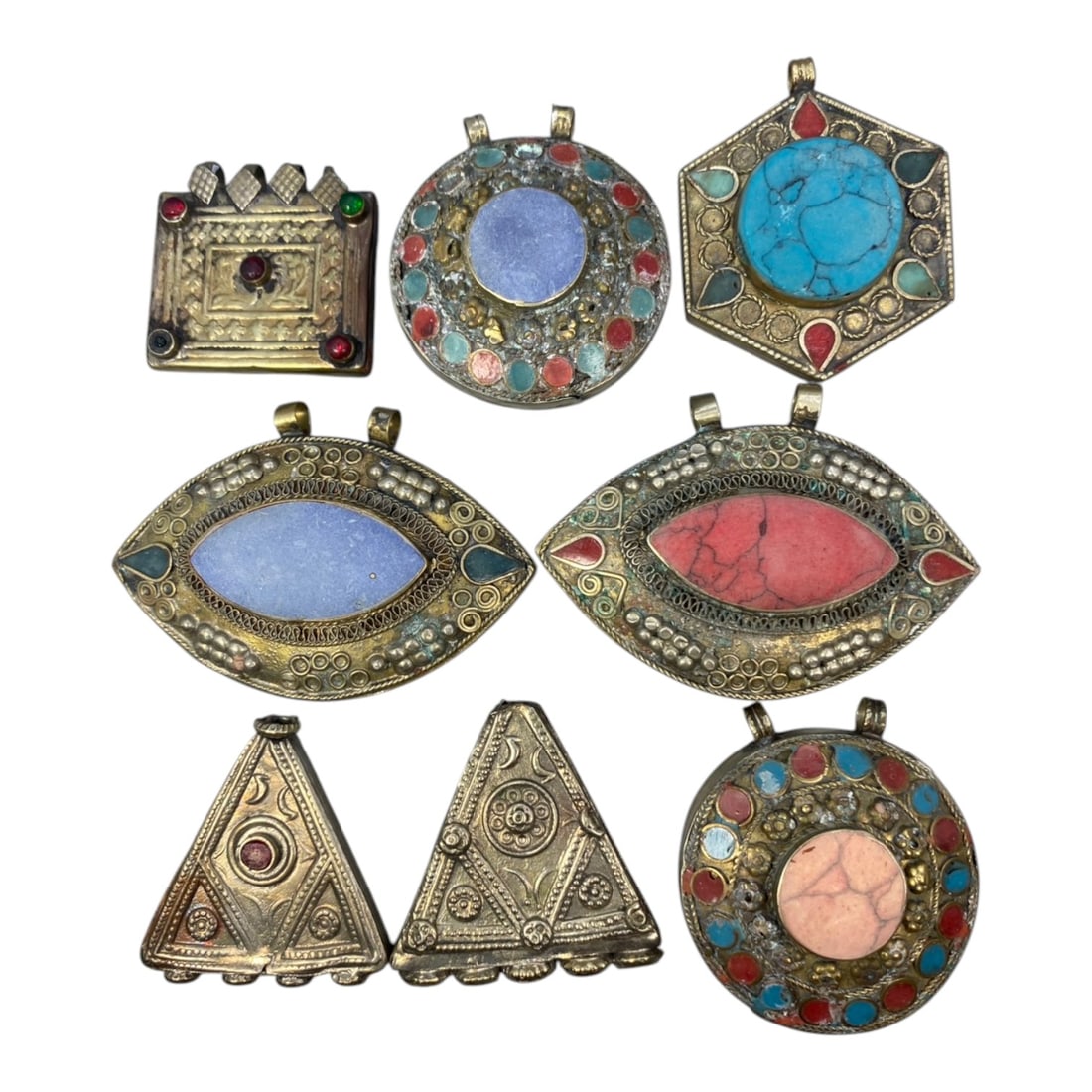 Antique Tribal Himalayan Metal & Stone Pendants - Set of 8, 15WK: A set of eight antique tribal Himalayan pendants, each crafted from aged metal with intricate filigree, embossed patterns, and colorful inset stones including turquoise, lapis lazuli, and coral-toned 