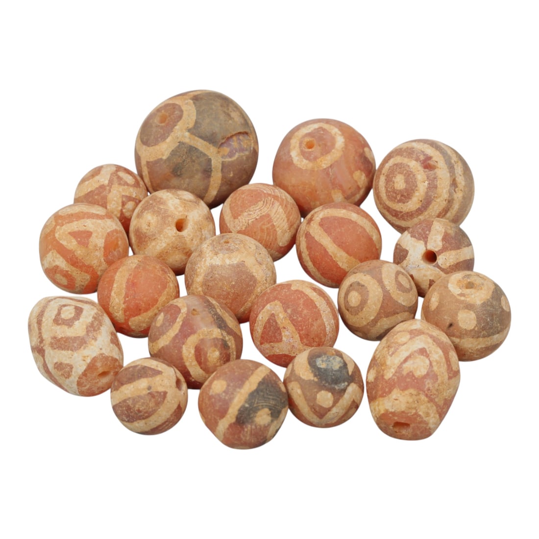 Lot of 20 Ancient Etched Carnelian Beads, Gandhara Period, 23WM: A group of 20 ancient etched carnelian beads from the Gandhara period. The beads are of varying round and slightly oval forms, crafted from reddish-orange carnelian stone. Each bead features intricate