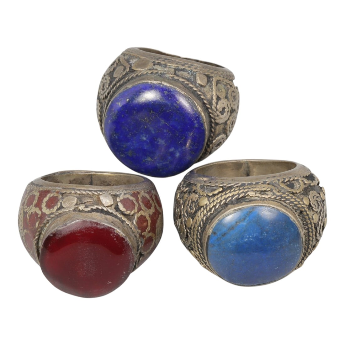 Lot of 3 Vintage Central Asian Tribal Silver Gemstone Rings, 50AD: A collection of three vintage tribal-style rings, characteristic of Central Asian folk jewelry traditions. Each ring is crafted from silver-toned metal with an aged patina, showcasing traditional twis