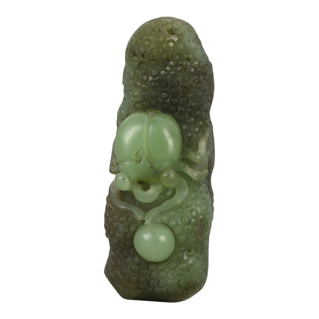 A Chinese Nephrite Jade Spider-and-Fruit Pendant, 20th Century, 12FB: Carved from green nephrite jade with darker mottling and areas of translucency, the pendant is modeled as an elongated fruit with a densely textured surface composed of rounded nodules. The front is c