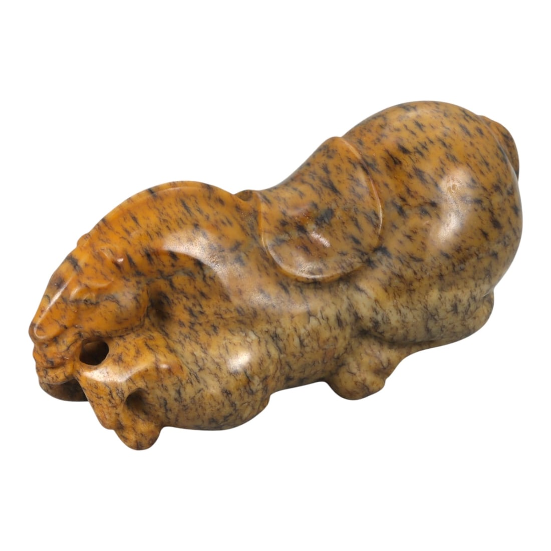 A Chinese Hardstone Recumbent Horse Figure, 20th Century, 84YA: Carved from mottled brown hardstone with dark veining and natural tonal variation, the figure is modeled in the round as a recumbent horse with legs folded beneath the body. The head is rendered with 