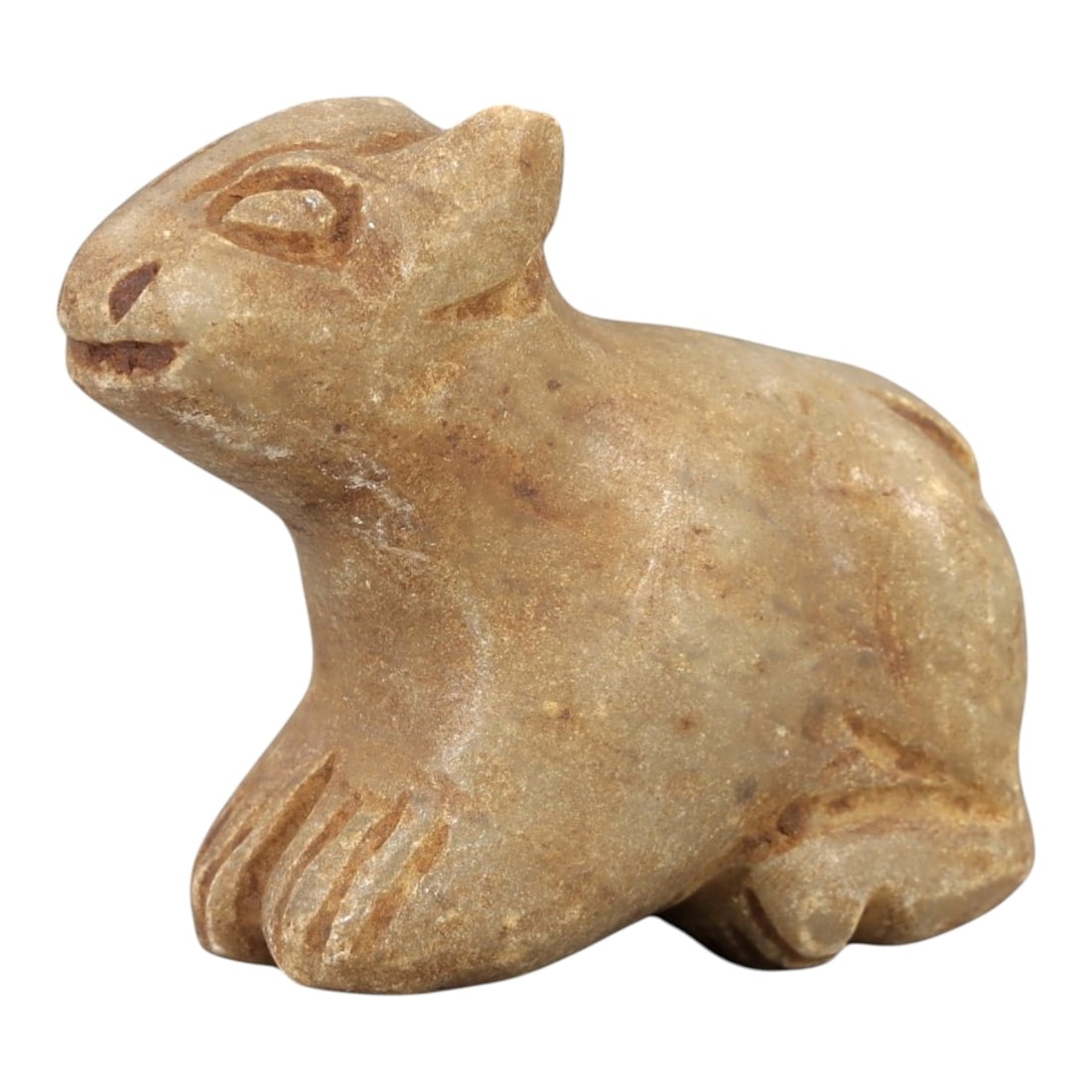 Ancient Stone Feline Amulet - Egyptian Figurine, 88AL: Carved from tan speckled stone, this amulet depicts a crouching feline, likely a cat or lion cub, with stylized incised facial features including almond-shaped eyes, a small nose, and a gently curved 