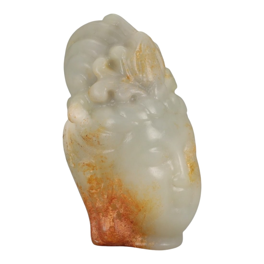 A Chinese Hetian Nephrite Jade Buddha Head, 20th Century, 51FD: Carved from pale celadon Hetian nephrite jade with areas of natural translucency and retained russet skin along the sides and rear. The sculpture represents the head of a Buddha, modeled with a rounde