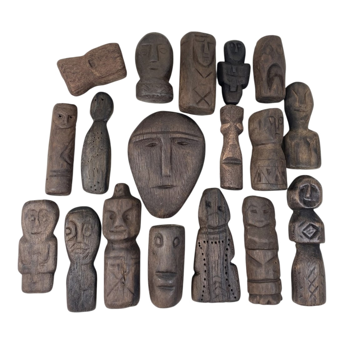 A Lot of 18 Antique African Tribal Wood Figures, 37AC: The group comprises eighteen carved wooden figures, each varying in form and stylistic detail, ranging from abstract heads and busts to full-bodied schematic representations. Crafted from dark hardwoo