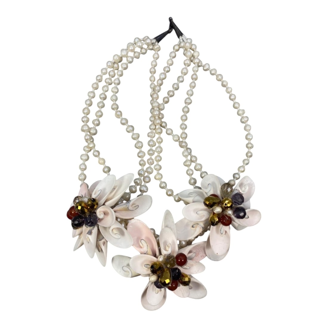 A Multi-Strand Shell and Natural Pearl Floral Necklace, Late 20th Century, 64FK: Constructed from four strands of small, uniform natural pearl beads, this necklace features three large floral pendants composed of carved shell petals in graduated shades of white and pale pink. Each