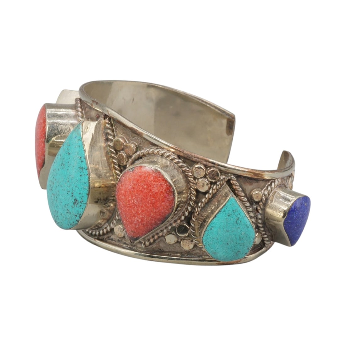 A Vintage Himalayan Silver-Plated Multi-Stone Cuff Bracelet, 35AH: A handcrafted vintage cuff bracelet, measuring approximately 6 cm in width, showcasing traditional Himalayan jewelry design. The piece features a silver-plated metal base, with alternating teardrop-sh
